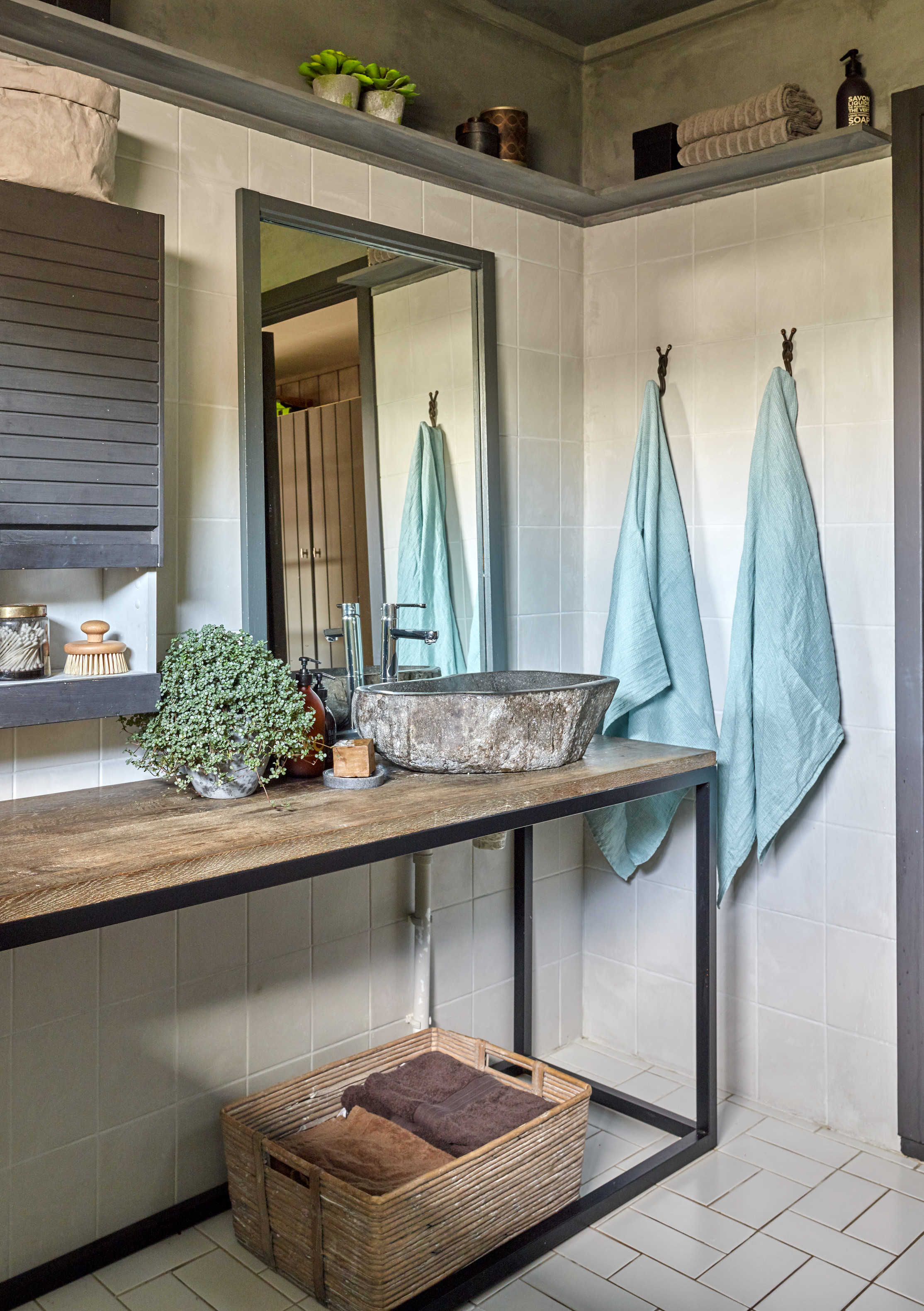 Grått bad med to turkise håndklær.